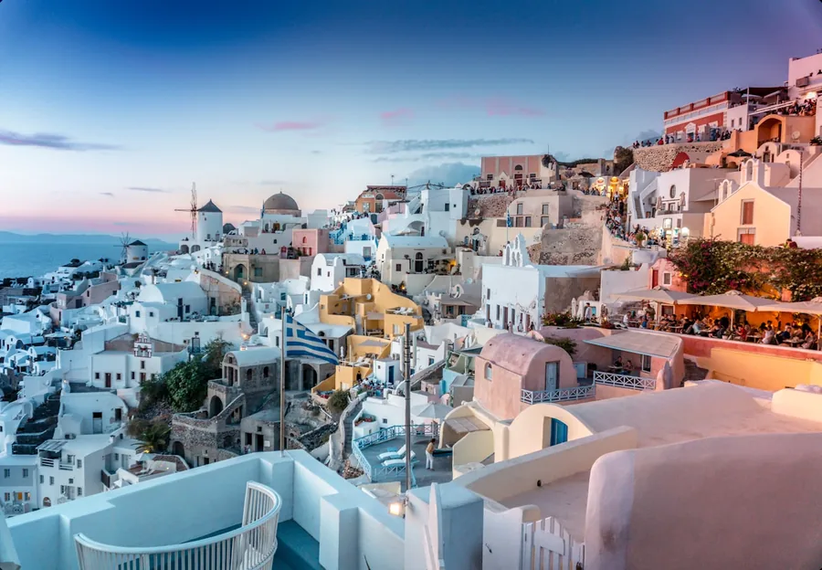Whitewashed clifftop villages and blue domes above the Aegean Sea in Santorini, Greece